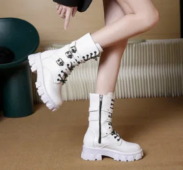 A pair of black women's mid-calf boots with a side zip and a round toe, showing the metal buckle detail.