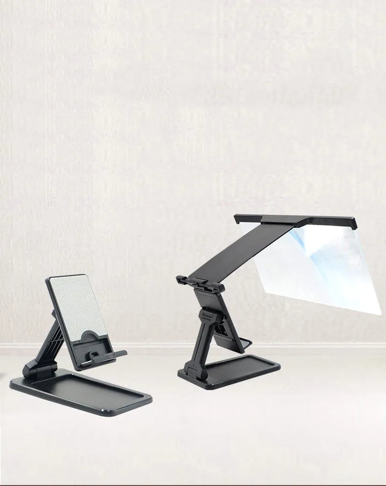 Black foldable mobile phone screen amplifier and detachable holder set up on a desk.