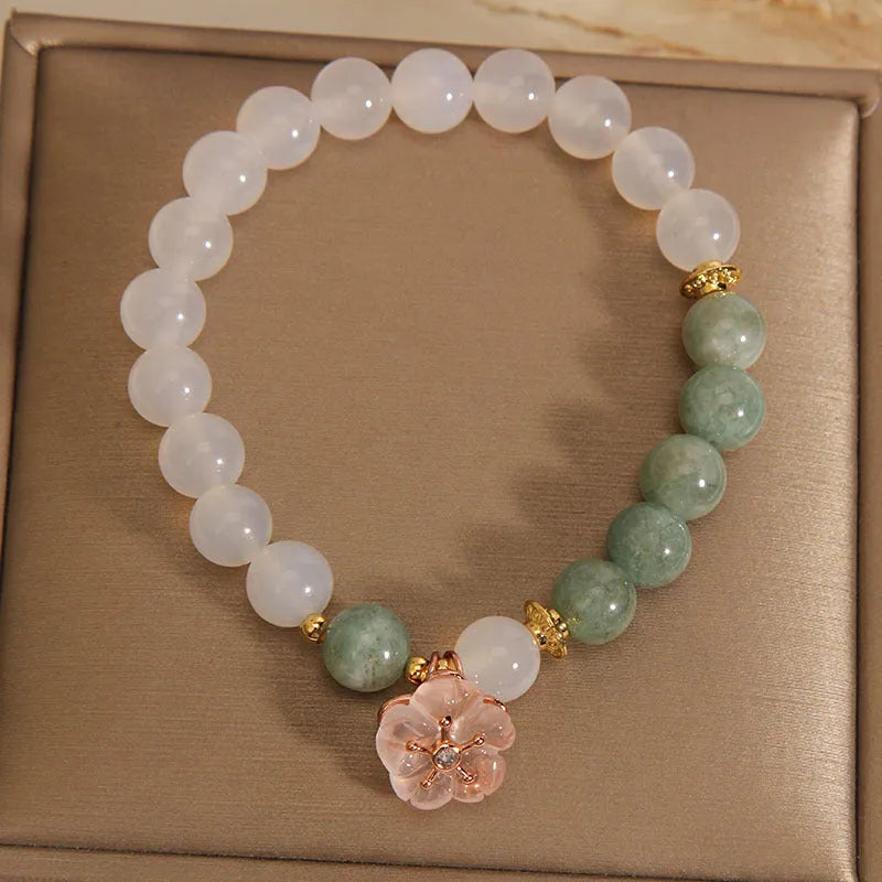 Women's floral bracelet made of white agate and jadeite stones set in jade.