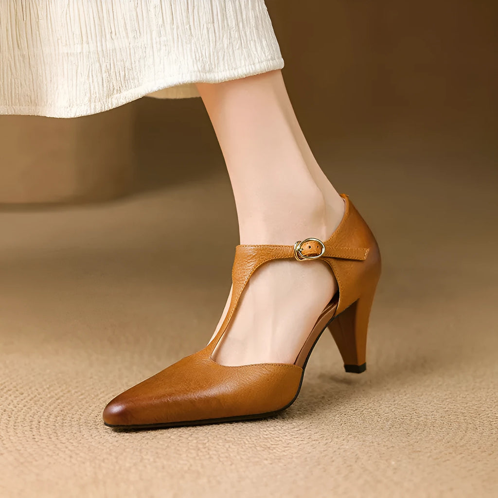 Brown retro women's T-strap sandals with a closed toe, block heel, and adjustable buckle.