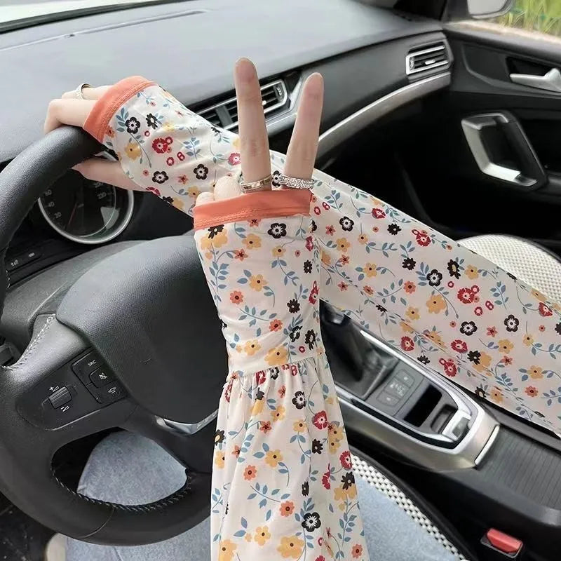 A pair of printed viscose oversleeve gloves in a floral pattern, showcasing sun protection for arms.