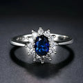 Electroplated copper ring with floral shape and zirconium inlay, shown in green, blue, and red colour options.