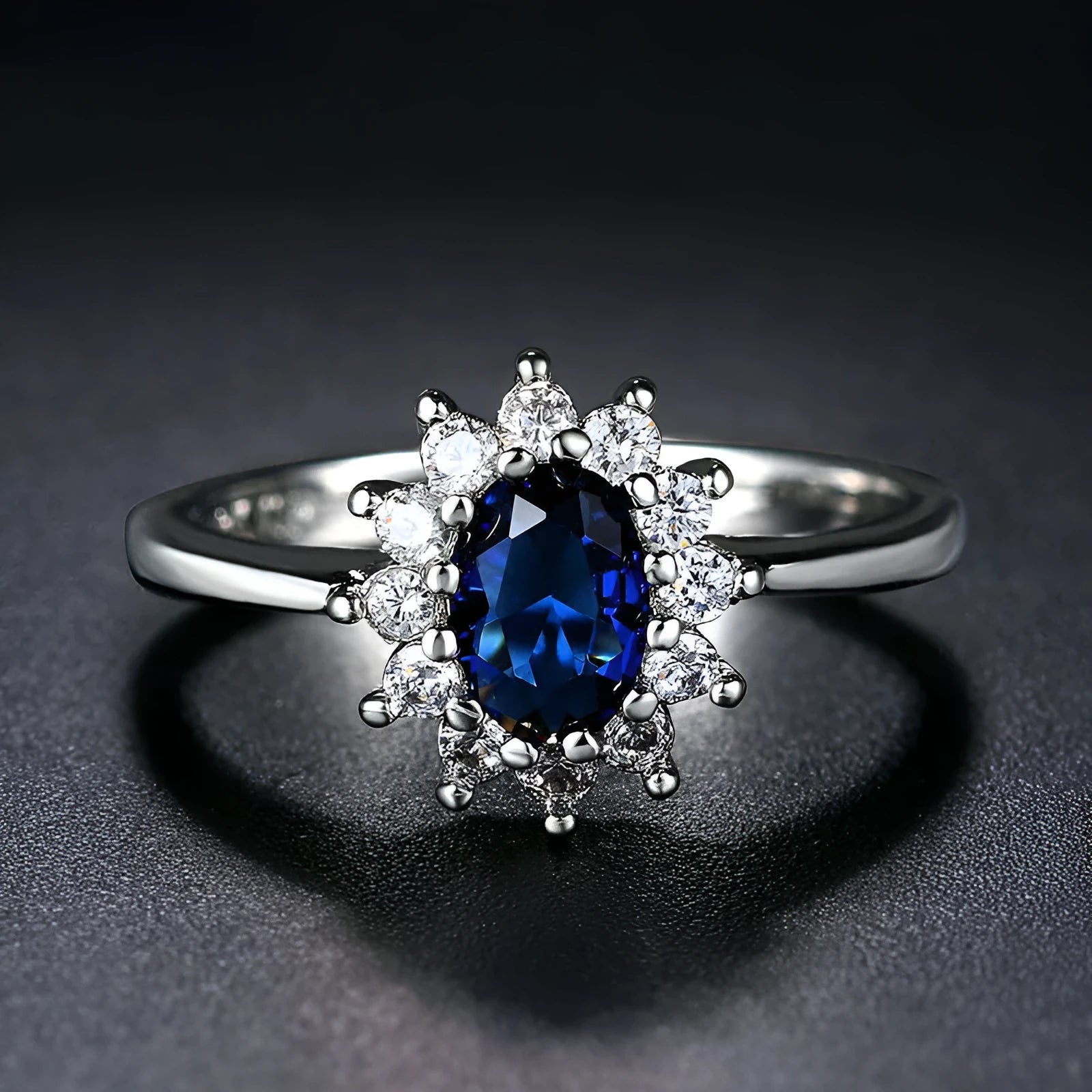 Electroplated copper ring with floral shape and zirconium inlay, shown in green, blue, and red colour options.