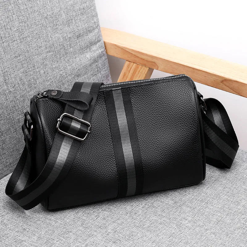 Black genuine leather one-shoulder crossbody bag showing dimensions and interior polyester lining