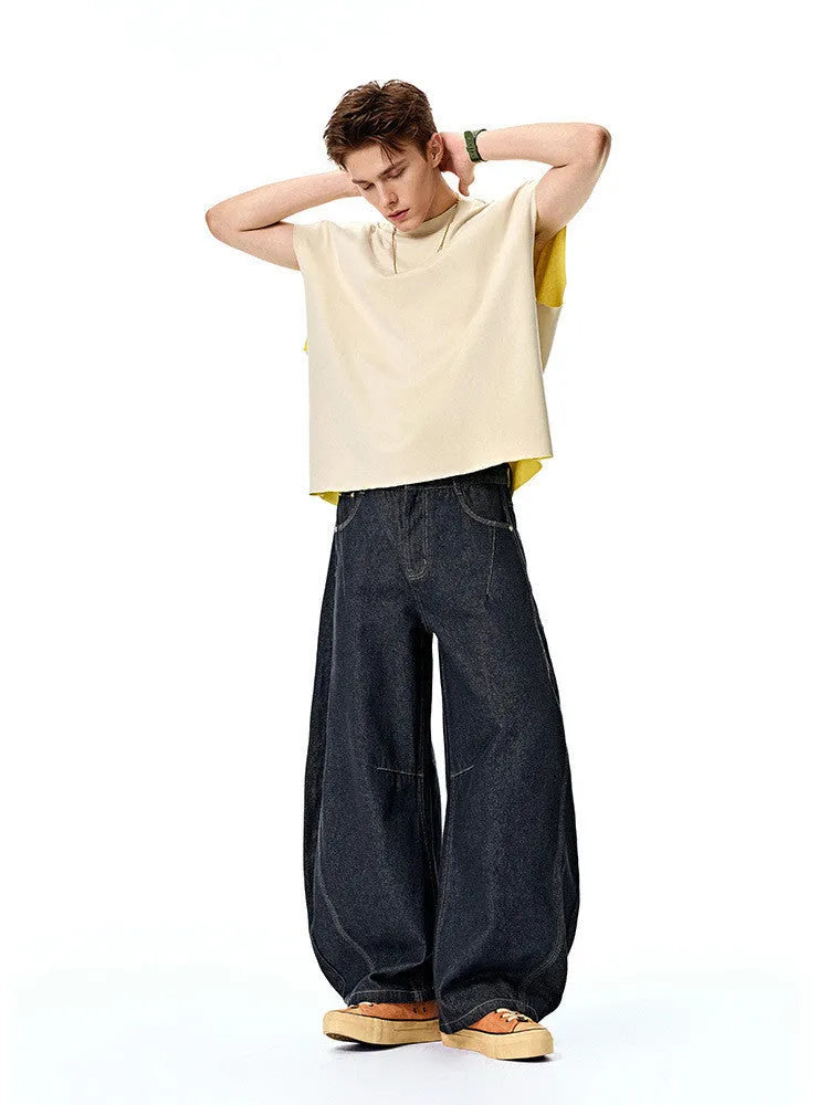 Men's wide leg denim trousers in original cow colour showing mid waist design and relaxed fit