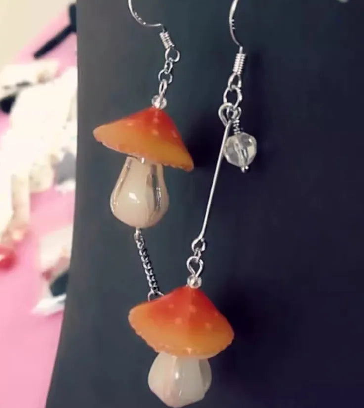 Resin heat shrinkable small mushroom earrings in yellow original style on plain background