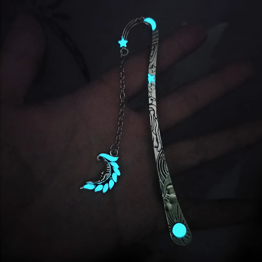 Metal bookmark with glowing five-pointed star and celestial sun moon stars design