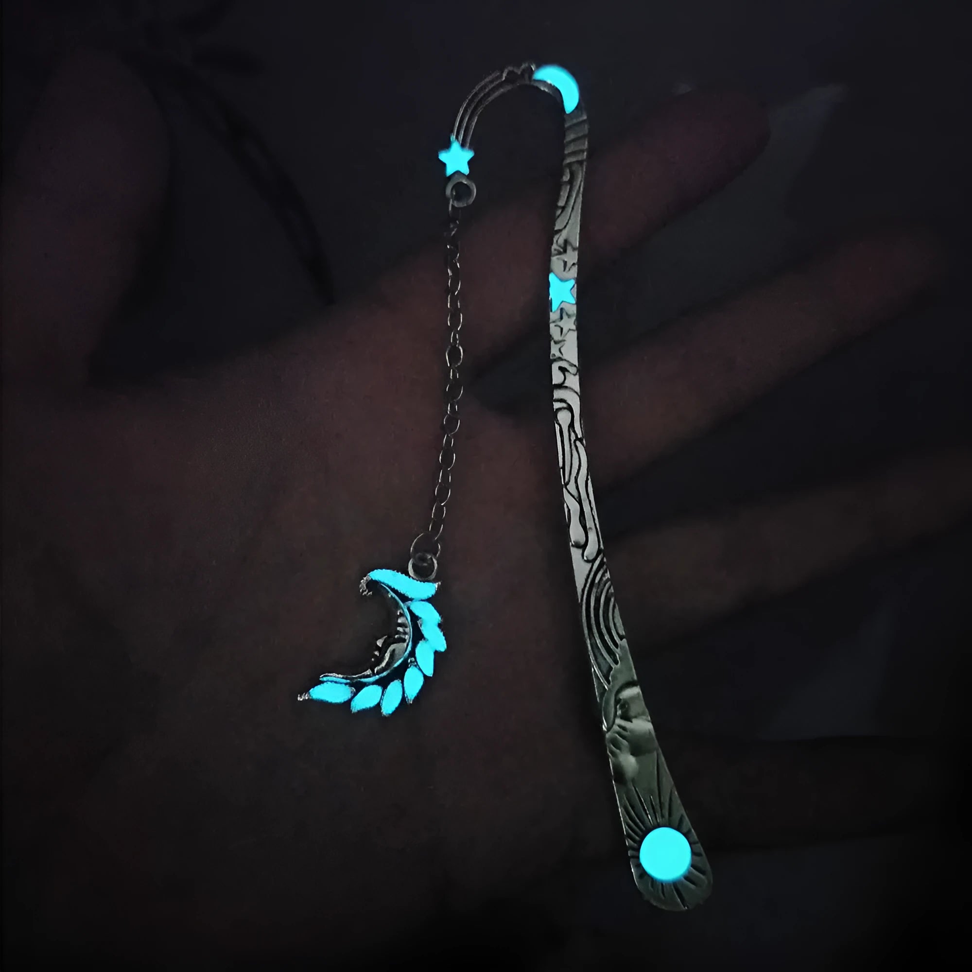 Metal bookmark with glowing five-pointed star and celestial sun moon stars design