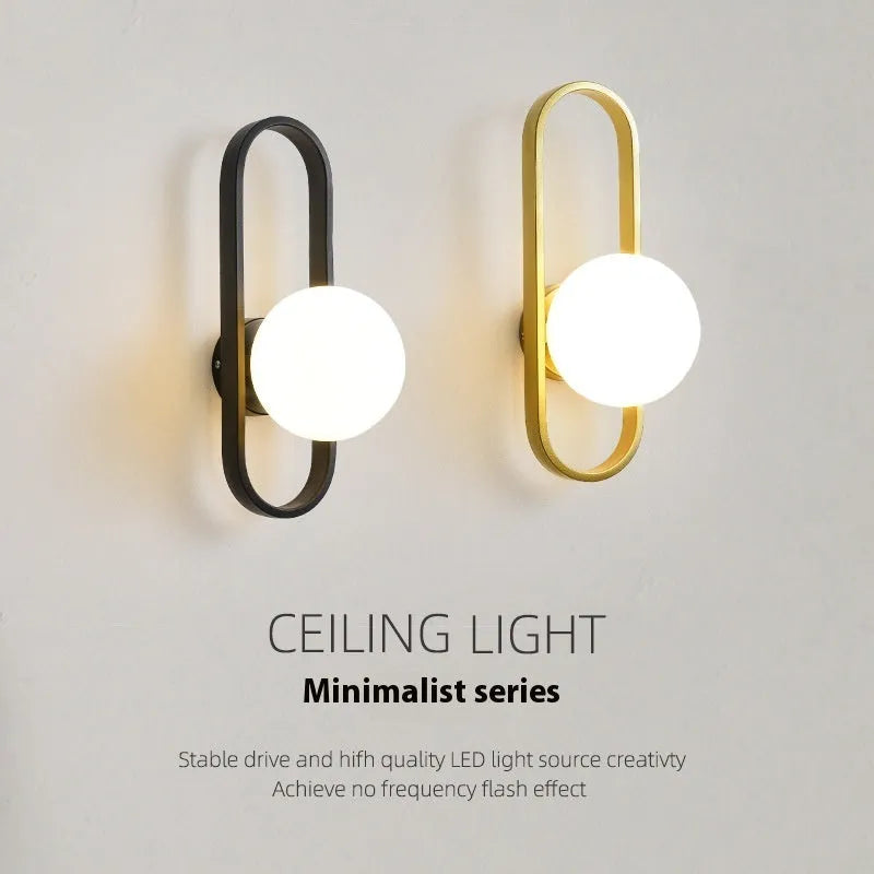 Modern minimalist wall lamp with glass shade and iron mount in black or gold finish