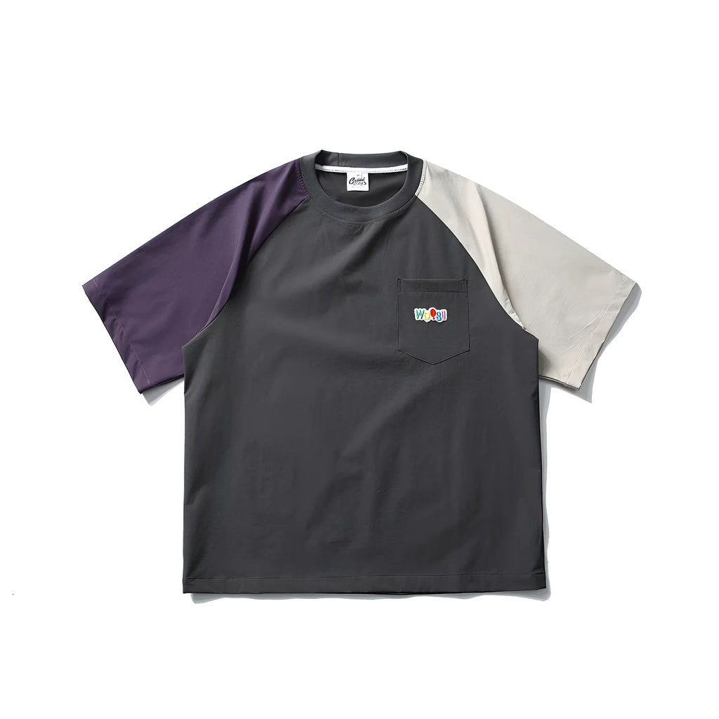 Dark grey men's loose-fit T-shirt with contrast raglan sleeves on a hanger.