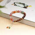 8mm persimmon orange agate bracelet with diamond-shaped beads on wrist