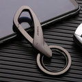 Black zinc alloy double ring key chain on a table, showing its 8.3cm length and compact design.