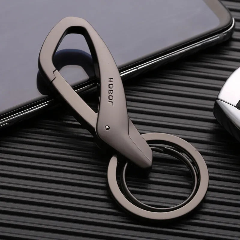 Black zinc alloy double ring key chain on a table, showing its 8.3cm length and compact design.
