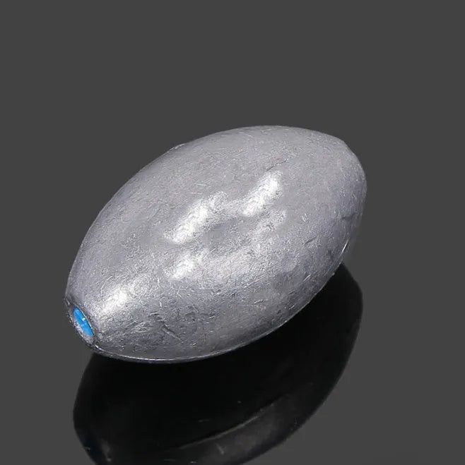 Olive-coloured rugby-shaped sea fishing sinker with a textured scale pattern, showing weight markings.