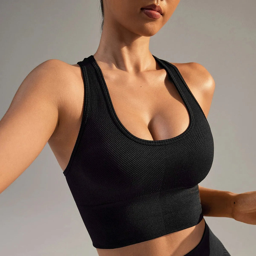 Black women's sports bra with cross-back design and moulded cups for yoga and running.