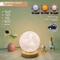 Rotating three-colour moon night lamp with wooden base in Nordic style, showing direct plug connection