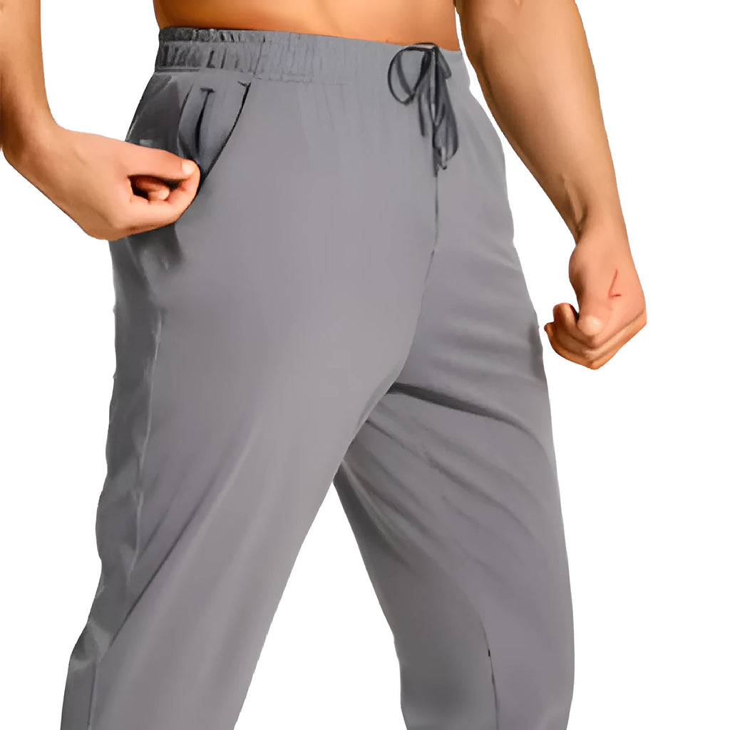 Man wearing loose-fit solid colour casual trousers made from polyester fabric.