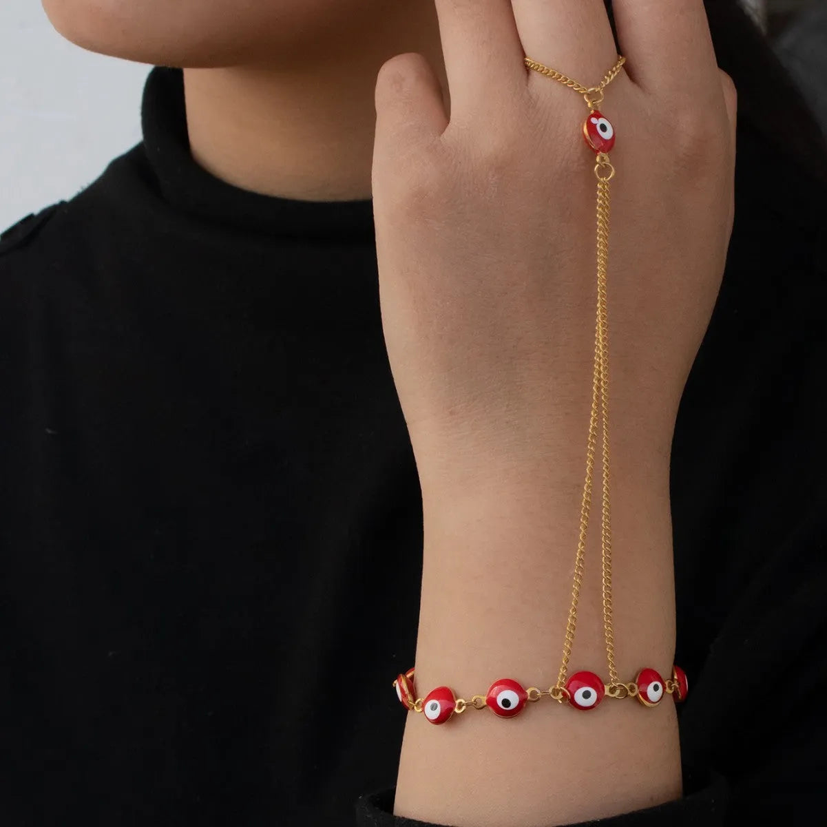 Women's titanium steel round eyes lucky mitten-type bracelet in colourful electroplated finish on a neutral background