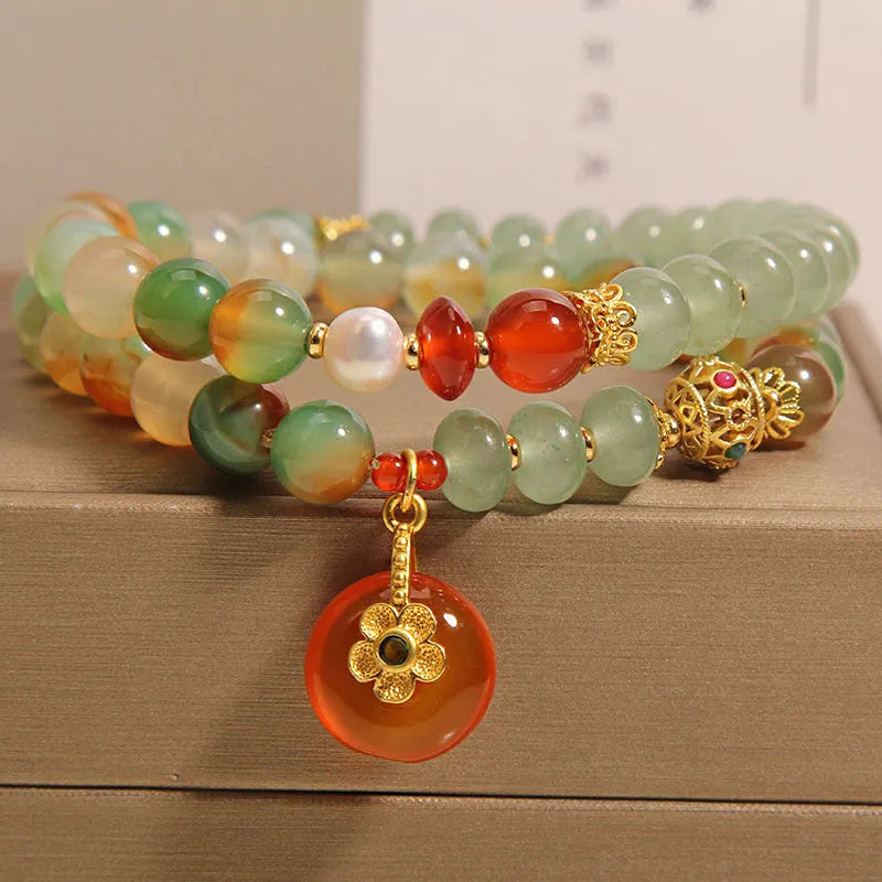 Women's peacock green agate double ring bracelet with alloy construction and safety buckle clasp.