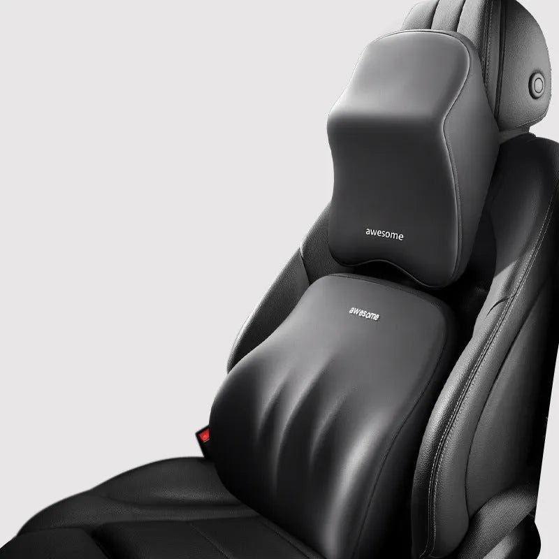 Black geometric pattern memory foam car lumbar pillow and matching headrest on a car seat.