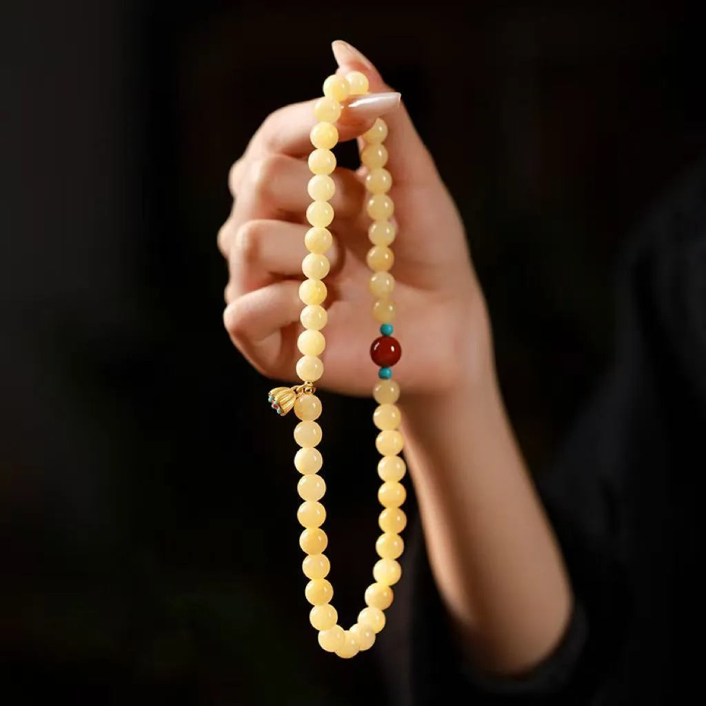 Handmade yellow jade double ring bracelet for women on a wrist, showing 6mm and 8mm size options.