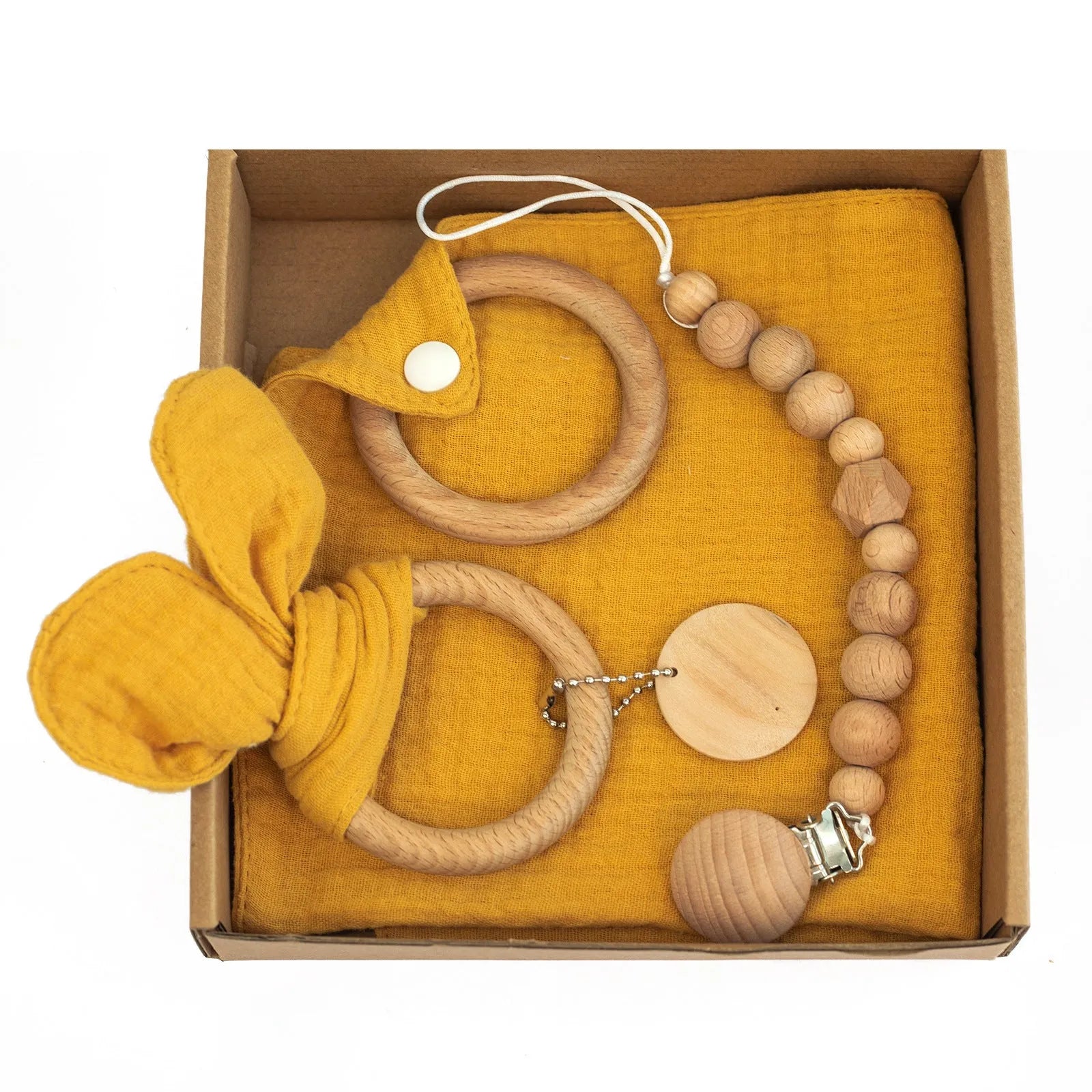Baby teething toy gift set showing gauze blanket, wooden bell, gum teether, tire brush, and milestone on white background