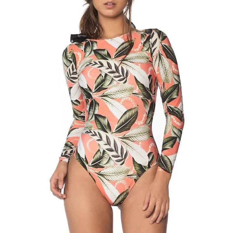 Women's backless one-piece swimsuit with green leaf print on black fabric.