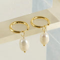 Gold geometric women's earrings with a pearl detail on a white background