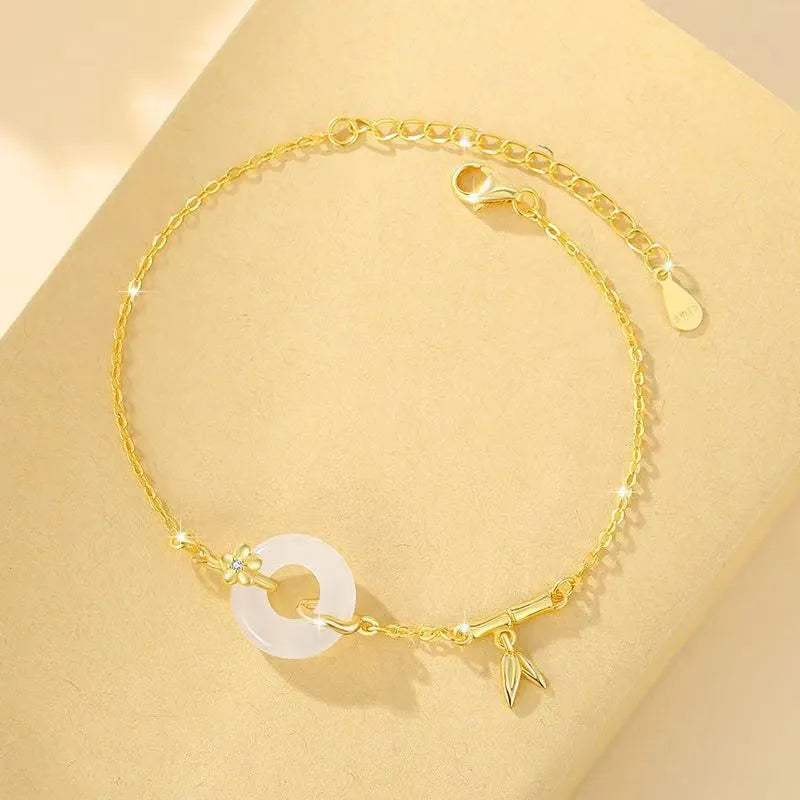 Silver women's bracelet with peace buckle charm, white chalcedony stone, and starry sky design with gold electroplating.