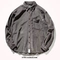 Caramel coloured loose fit corduroy cardigan shirt with long sleeves on a hanger.