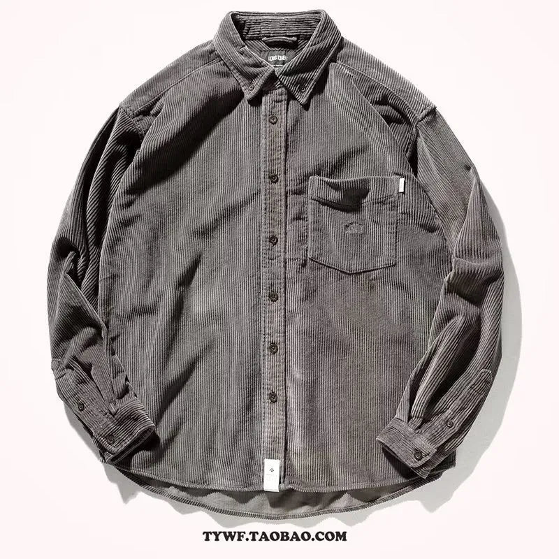 Caramel coloured loose fit corduroy cardigan shirt with long sleeves on a hanger.