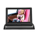 Black 4.3-inch car baby monitor with folding screen and rear view camera on a car dashboard