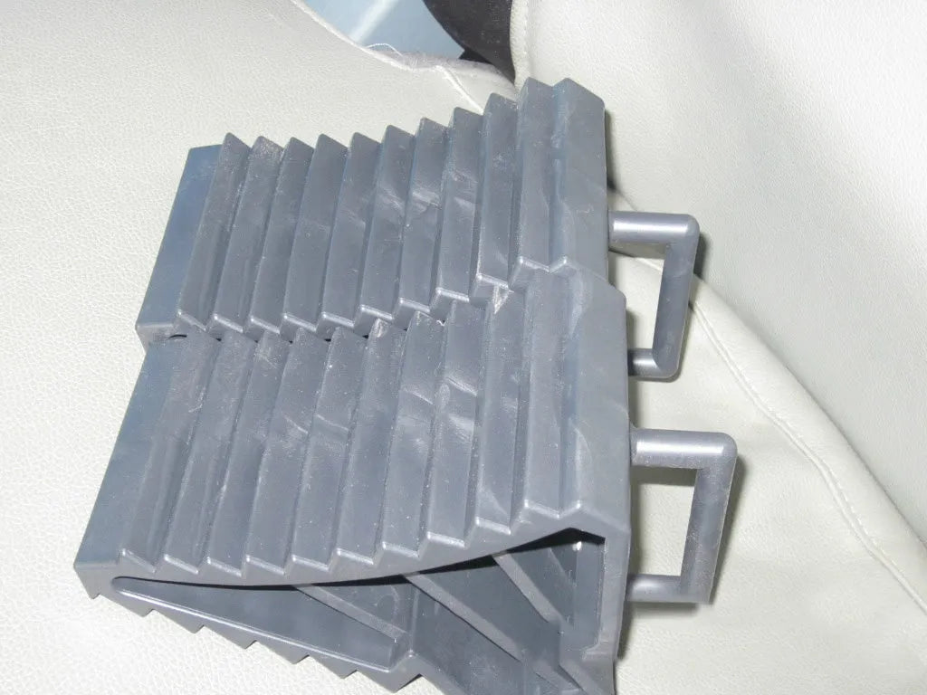Pair of triangular car wheel stoppers in black colour with storage boxes