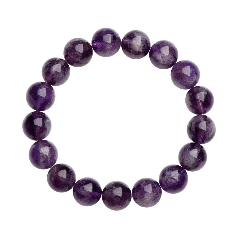 Natural feather amethyst crystal bracelet with scattered geometry beads and Ruyi element on a wrist.