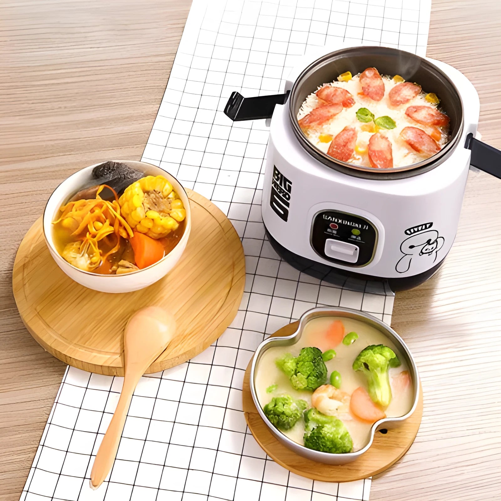 Compact round miniature rice cooker with non-stick pot and separate steam pan.