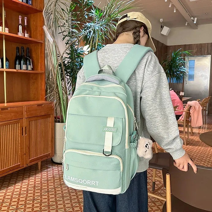 Waterproof nylon school backpack in colour options with curved shoulder straps and pendant attachment