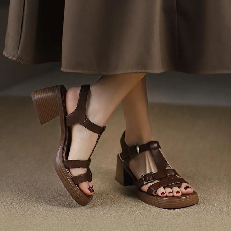 Women's black retro sandals with a chunky heel, platform, and T-shaped buckle fastening.