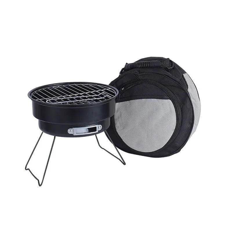 Small folding round metal ice stove with grill mesh and legs set up for outdoor barbecuing.