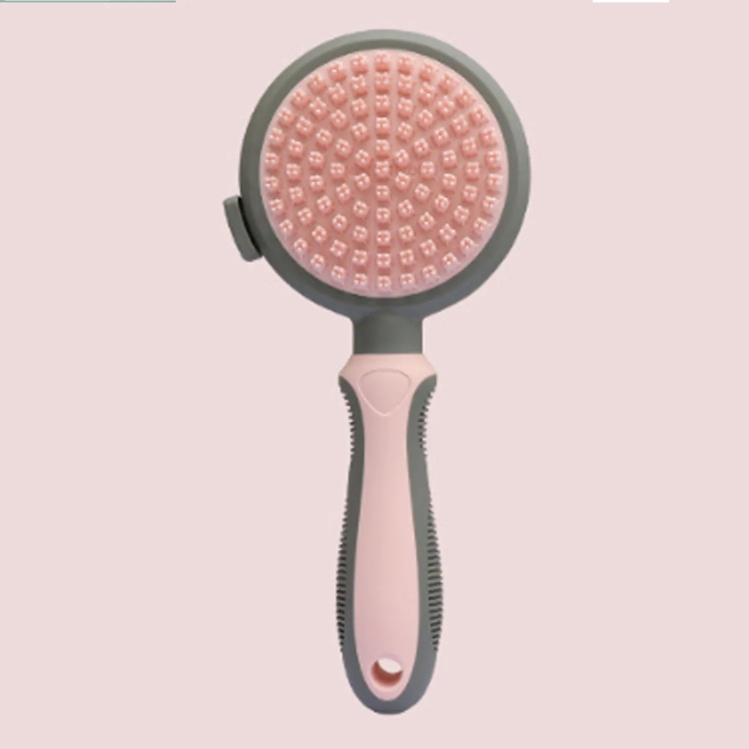 Pink and green double sided cat grooming brush showing slicker brush and flea comb sides with release button.