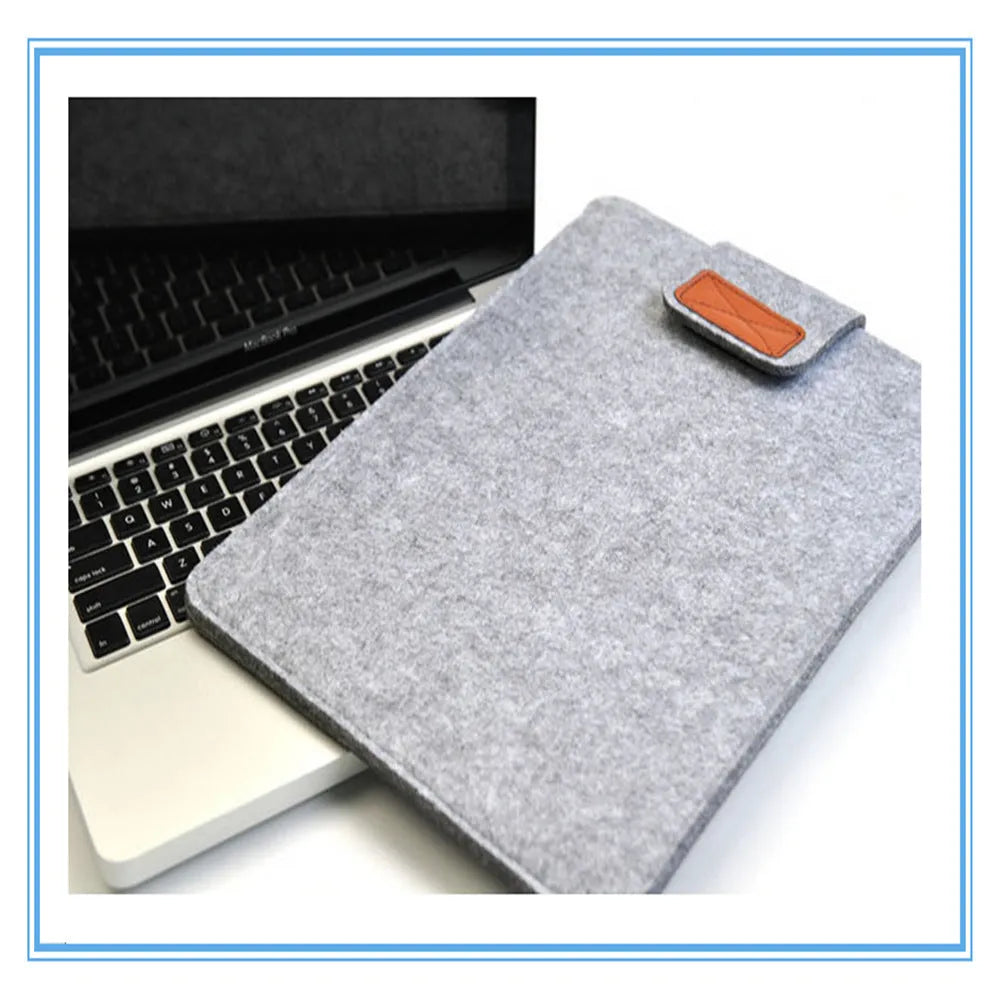 Vertical clamshell laptop bag in grey with plush felt interior and waterproof polyester exterior