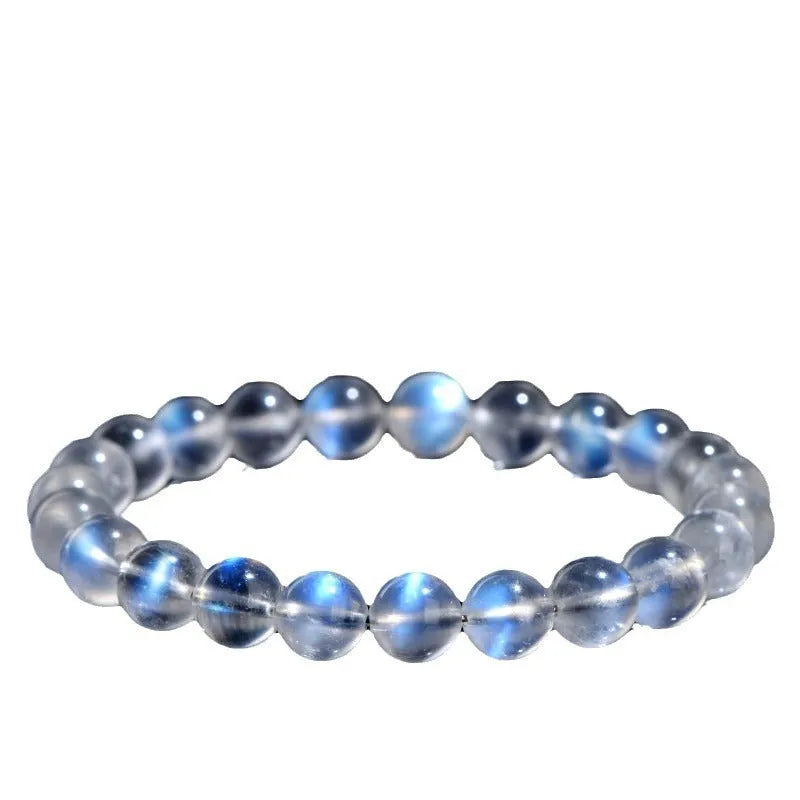 Natural blue moonlight crystal bracelet with cream body beads on a white background.