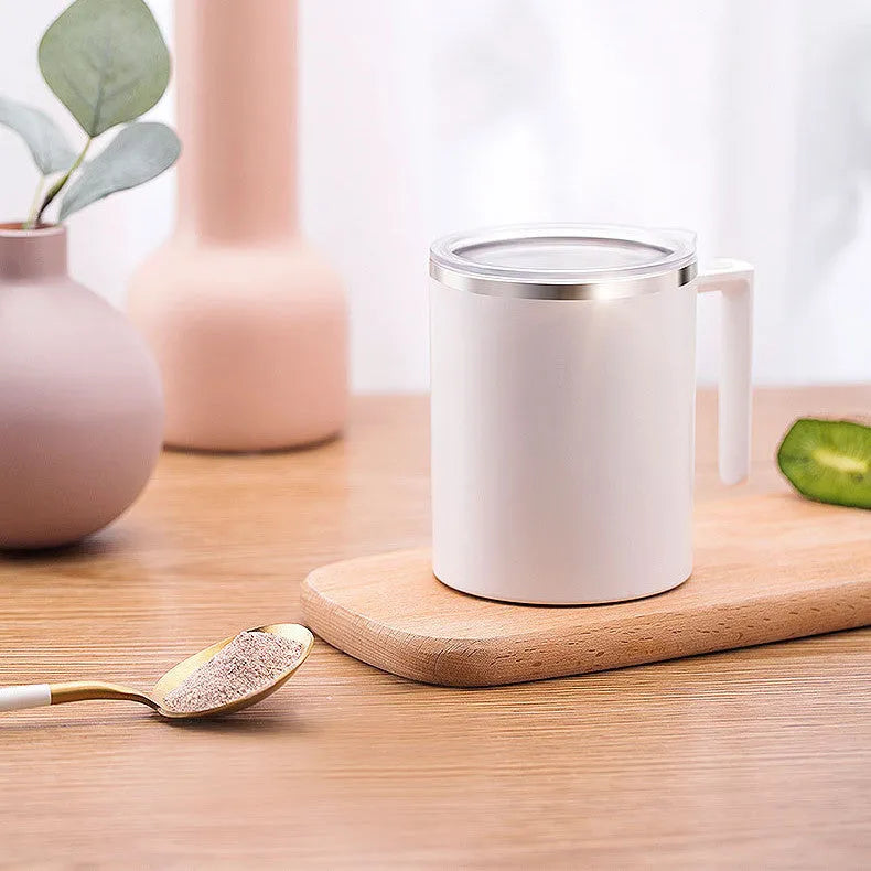 White automatic self-stirring coffee cup with magnetic base and power button.
