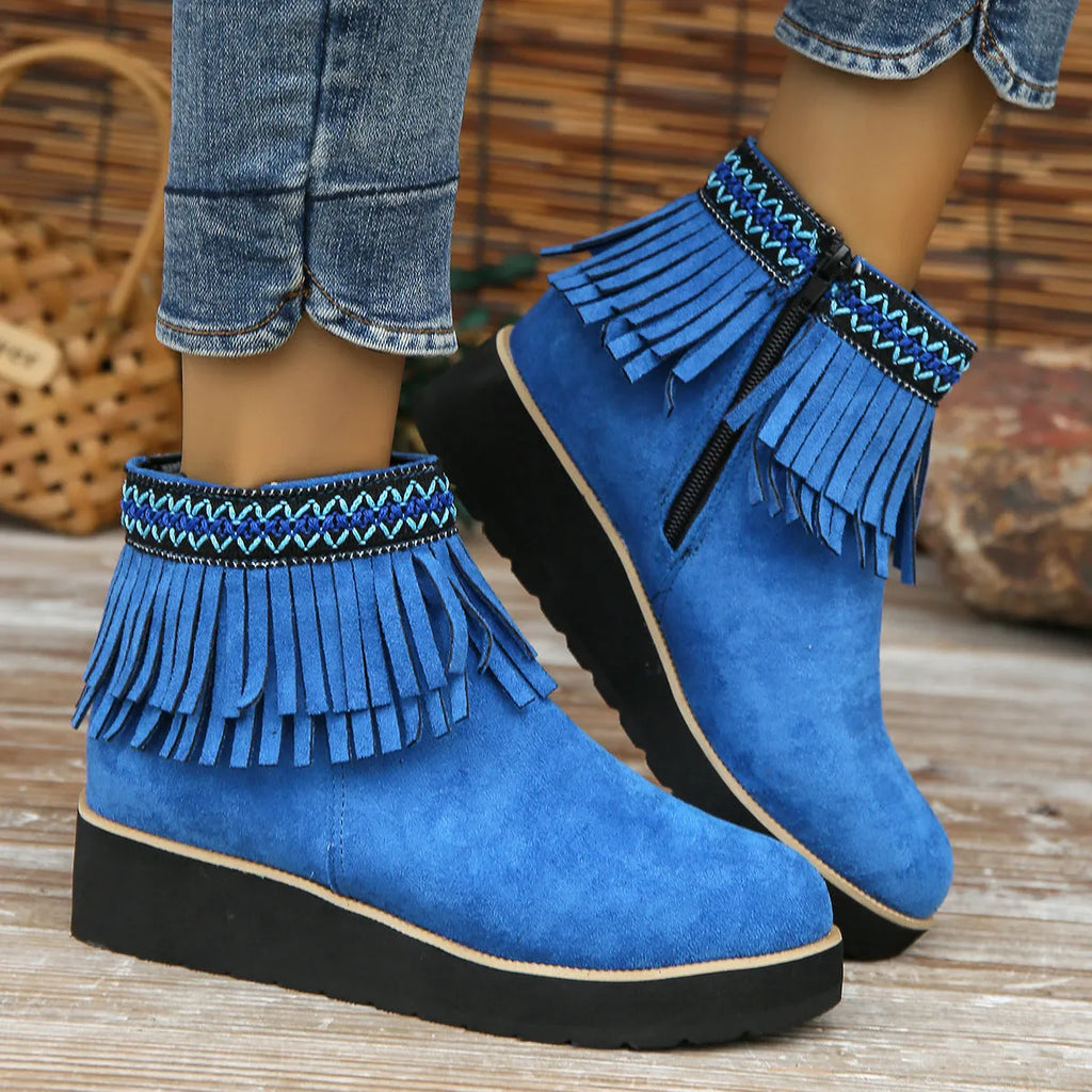 Women's dark brown suede ankle boots with a wedge heel, thick platform sole, tassel detail, and side zipper.