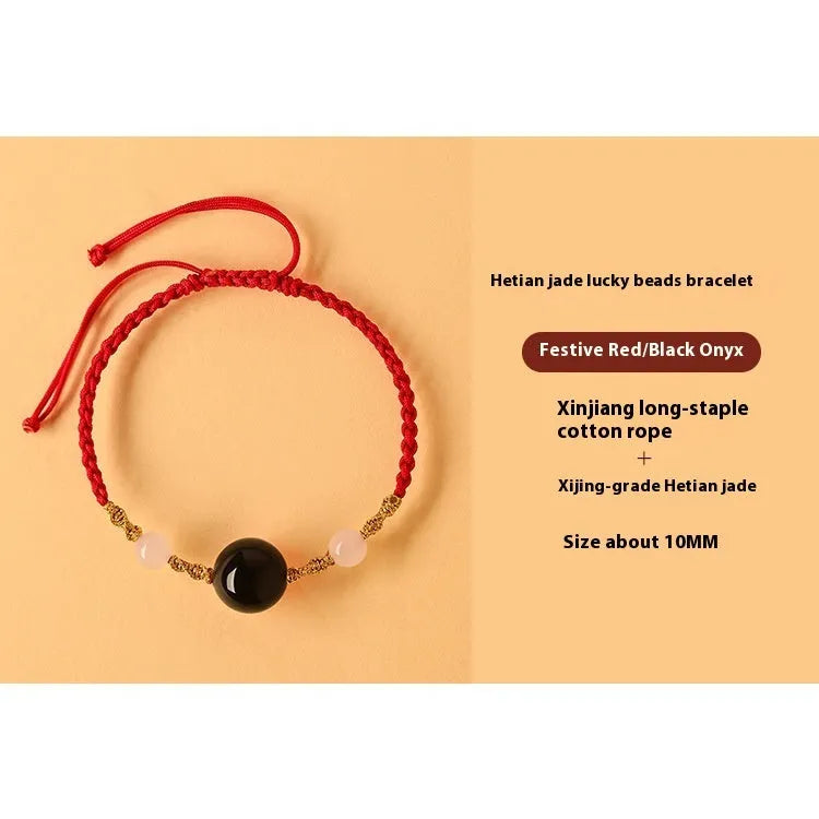 Hand-woven red rope bracelet with Hetian jade beads featuring traditional Chinese cultural symbols
