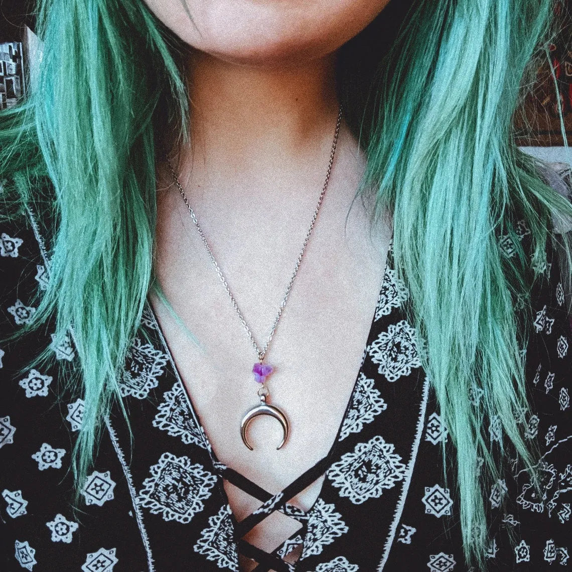 Silver moon-shaped pendant necklace with purple natural crystal centrepiece on alloy chain