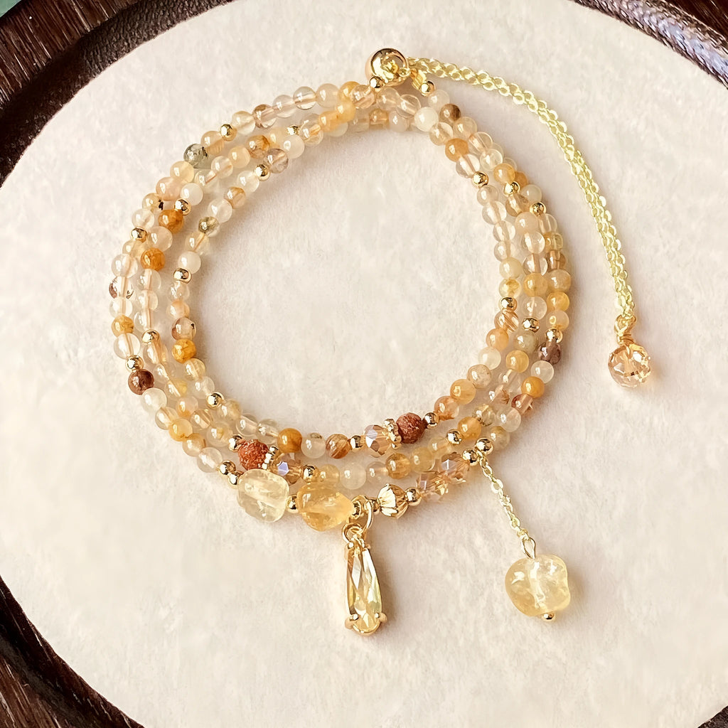 Gold multi-layer bracelet with citrine crystals and three-circle Saturn design