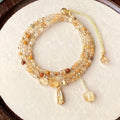 Gold multi-layer bracelet with citrine crystals and three-circle Saturn design