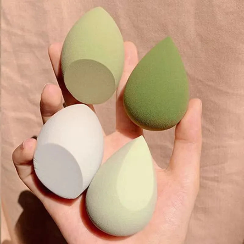 Seven different shaped makeup sponge puffs in various colours including pink, blue and burgundy