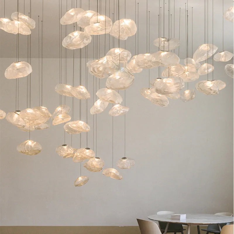 Modern light luxury glass chandelier in amber, clear, and smoke grey colours for lounge lighting.