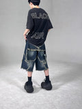 Blue denim shorts with frayed five-pointed star design and loose fit construction